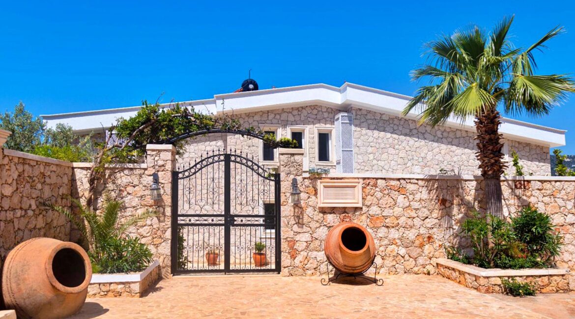 Villa Bahce Kalkan exterior with stone façade and gated entrance in Komurluk
