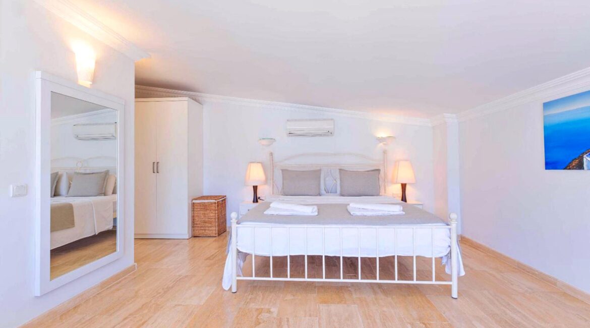 Bright double bedroom at Villa Bahce Kalkan with large bed and minimalist décor.