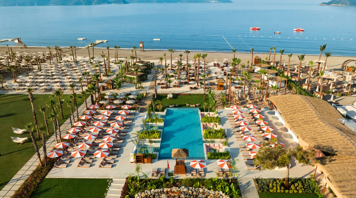 Aerial view of the main pool and private beach at XO Cape Arnna resort
