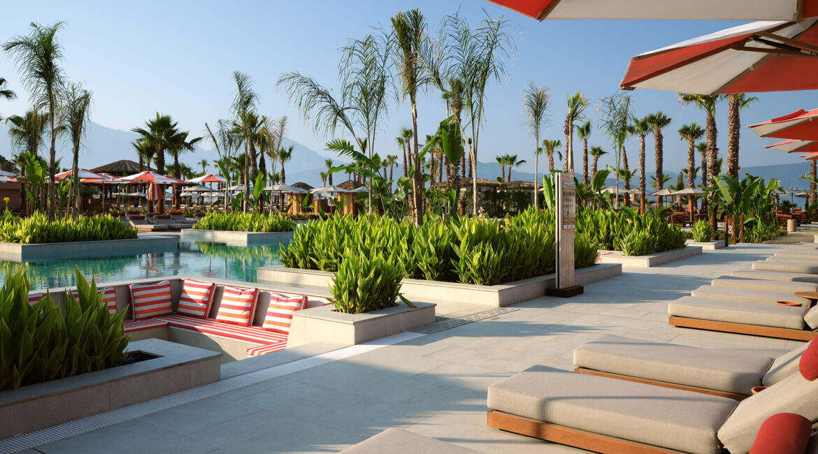 Poolside sun loungers and terraces at XO Cape Arnna resort in Fethiye