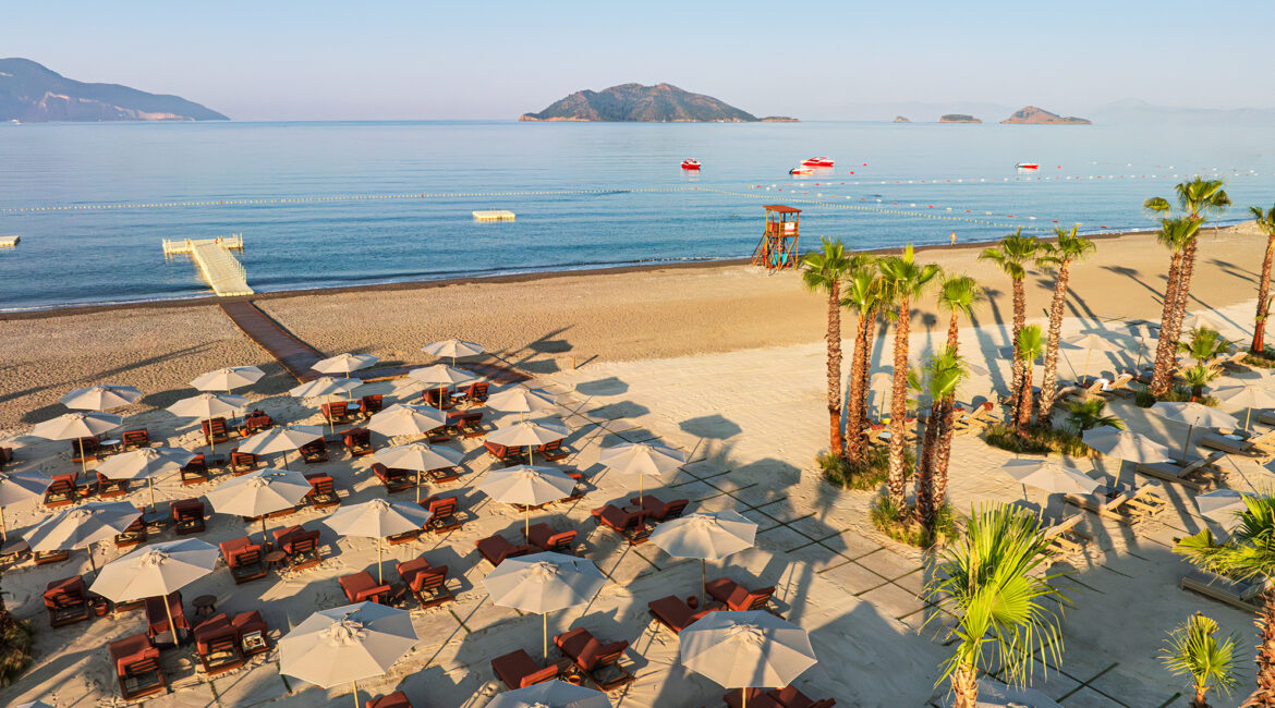 XO Cape Arnna beach lounge with sunbeds and parasols overlooking the sea in Fethiye