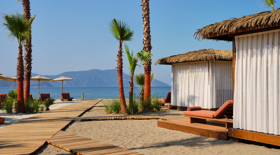 Seafront cabana and sun loungers on the private beach at XO Cape Arnna