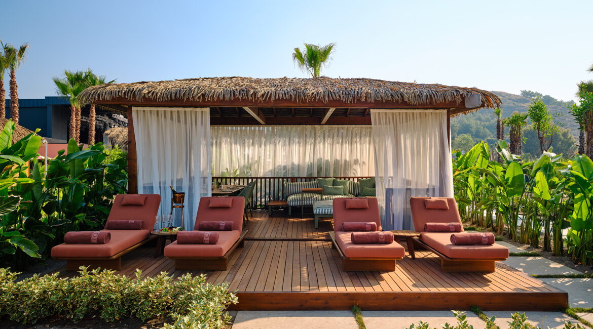 Shaded luxury beach cabana at XO Cape Arnna overlooking the Mediterranean