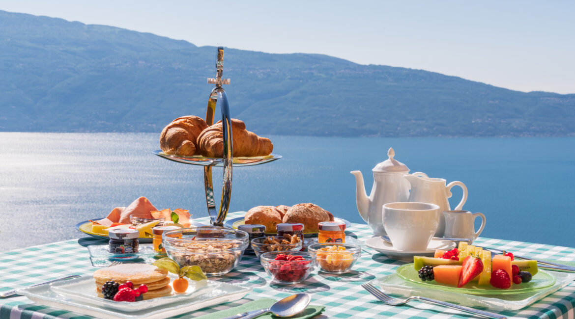 Breakfast table overlooking Lake Garda at Villa Sostaga boutique hotel