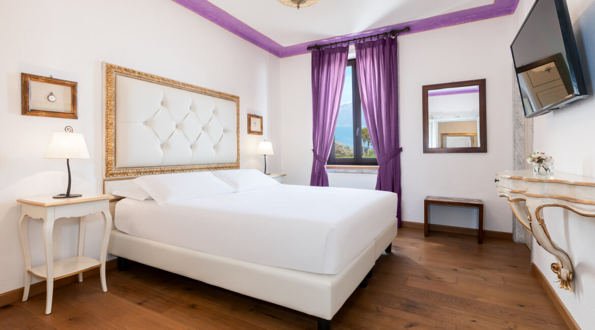 Bright guest bedroom with classic Italian design at Villa Sostaga