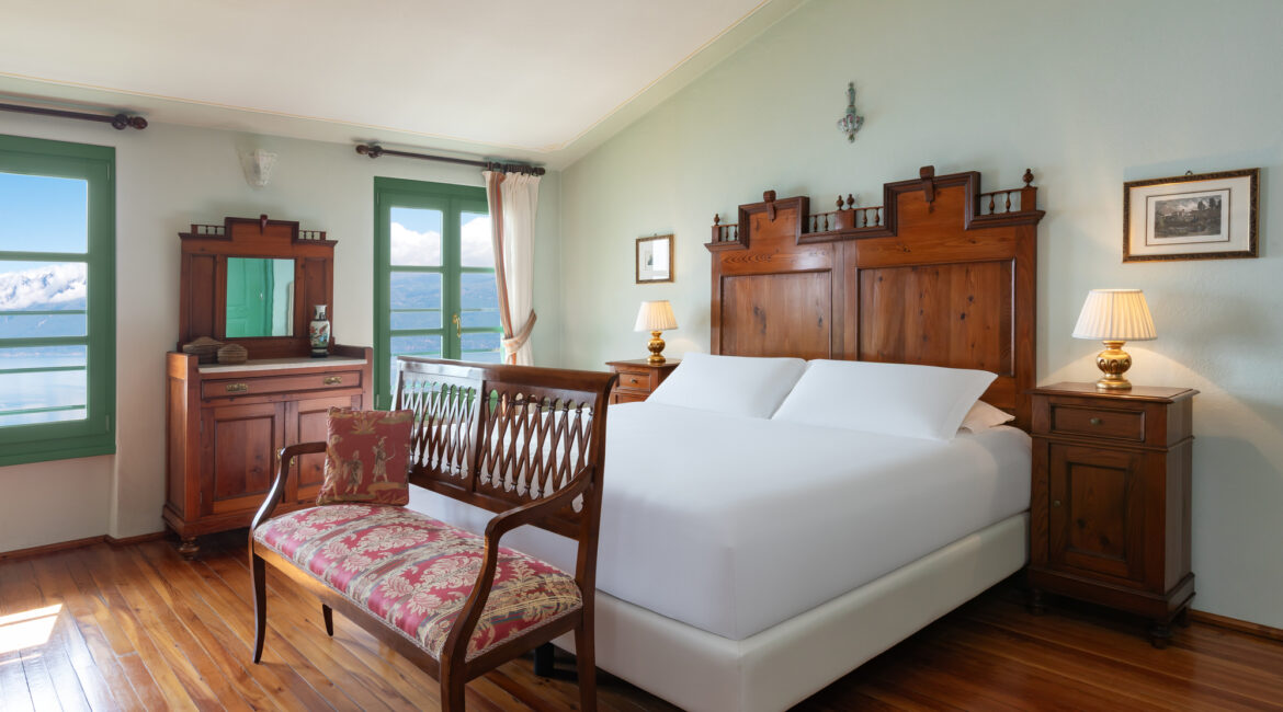 Comfortable guest room at Villa Sostaga with traditional Italian furnishings