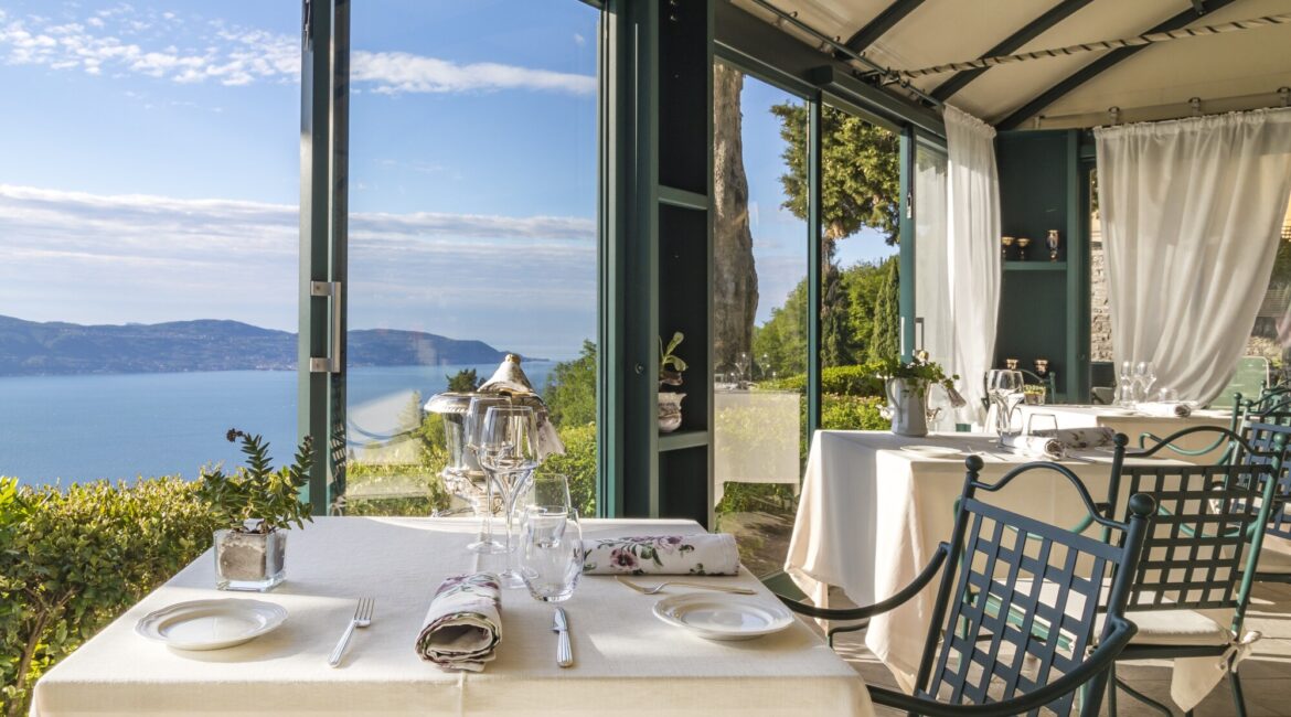 Covered terrace restaurant at Villa Sostaga with sweeping Lake Garda views