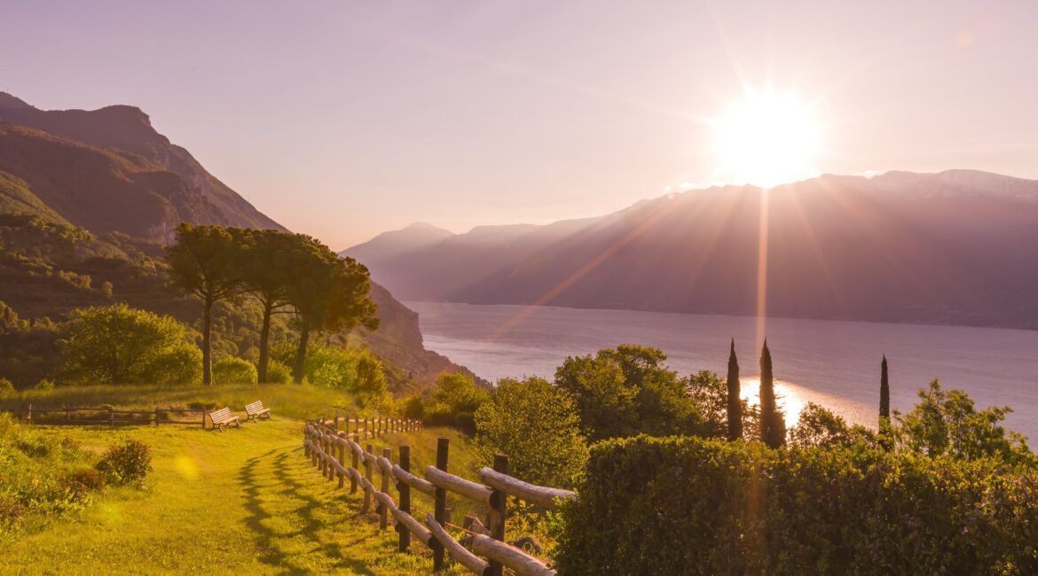 Golden sunset over Lake Garda viewed from the gardens of Villa Sostaga