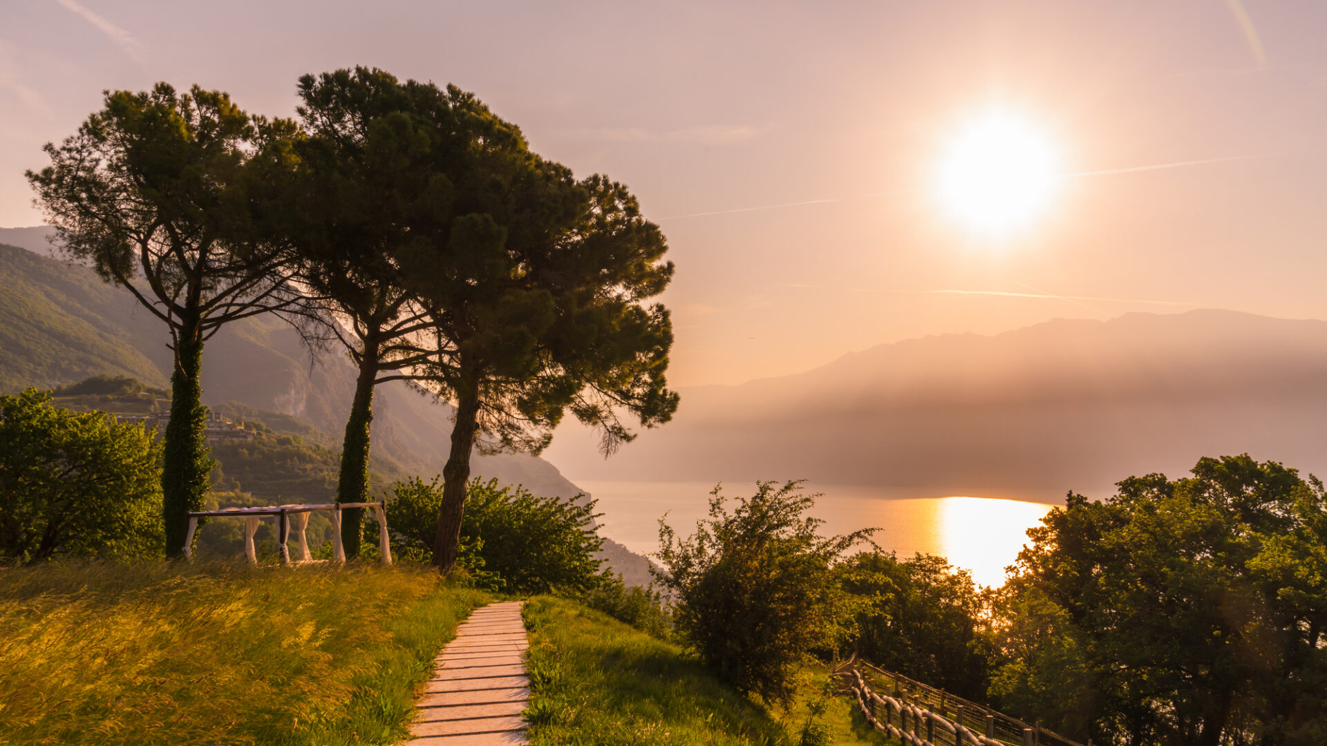 Golden sunset path through the gardens at Villa Sostaga overlooking Lake Garda