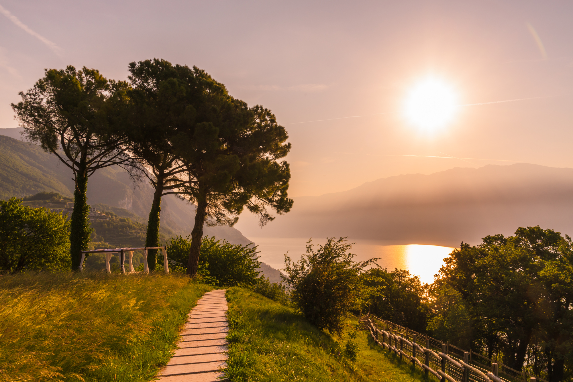 Golden sunset path through the gardens at Villa Sostaga overlooking Lake Garda