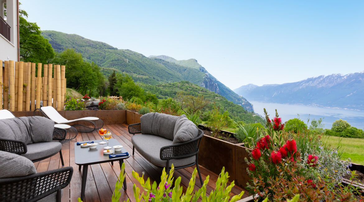 Outdoor furnished terrace with panoramic views across Lake Gard
