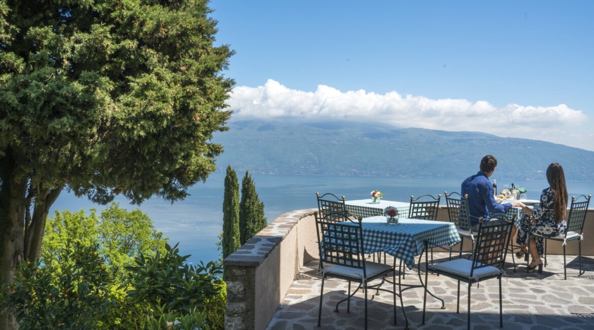Outdoor terrace dining with lake views at Villa Sostaga boutique hotel