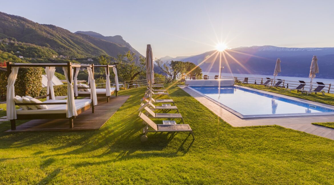 Swimming pool and relaxation terrace at Villa Sostaga during sunset
