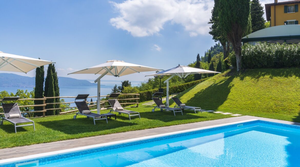 Swimming pool and terrace at Villa Sostaga with sweeping views across Lake Garda