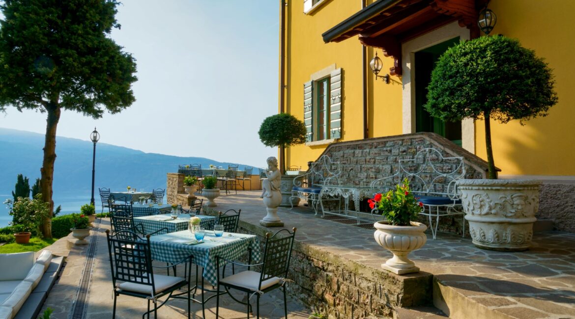 Terrace seating beside the historic villa at Villa Sostaga overlooking Lake Garda