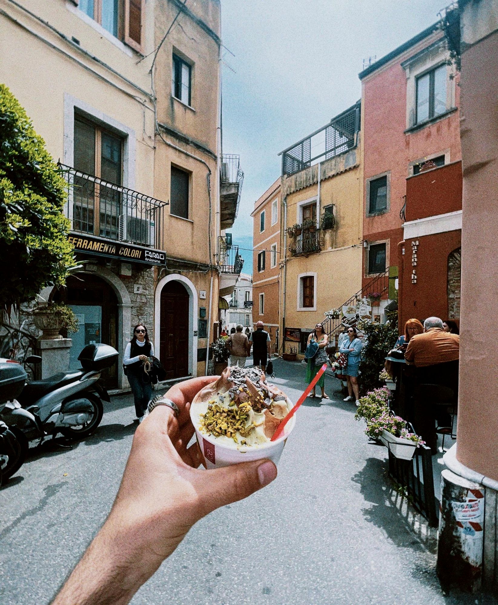 Colourful Italian street scene near Lake Garda with traditional buildings and aperitivo culture