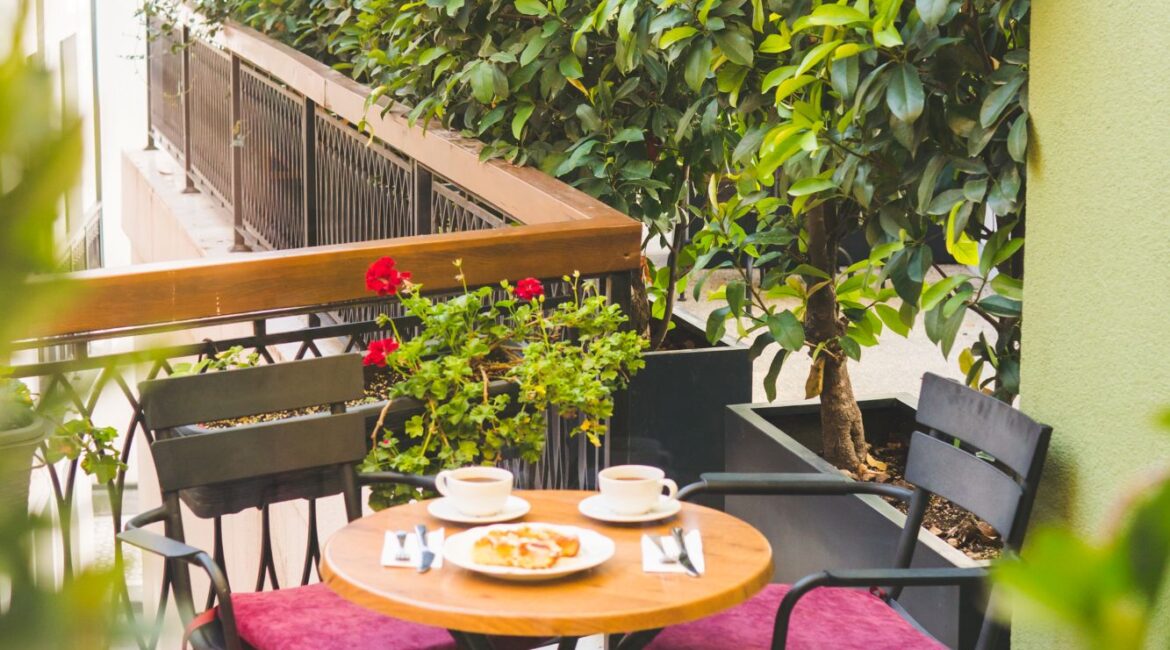 Outdoor terrace for breakfast at Hotel Poem in Istanbul surrounded by greenery