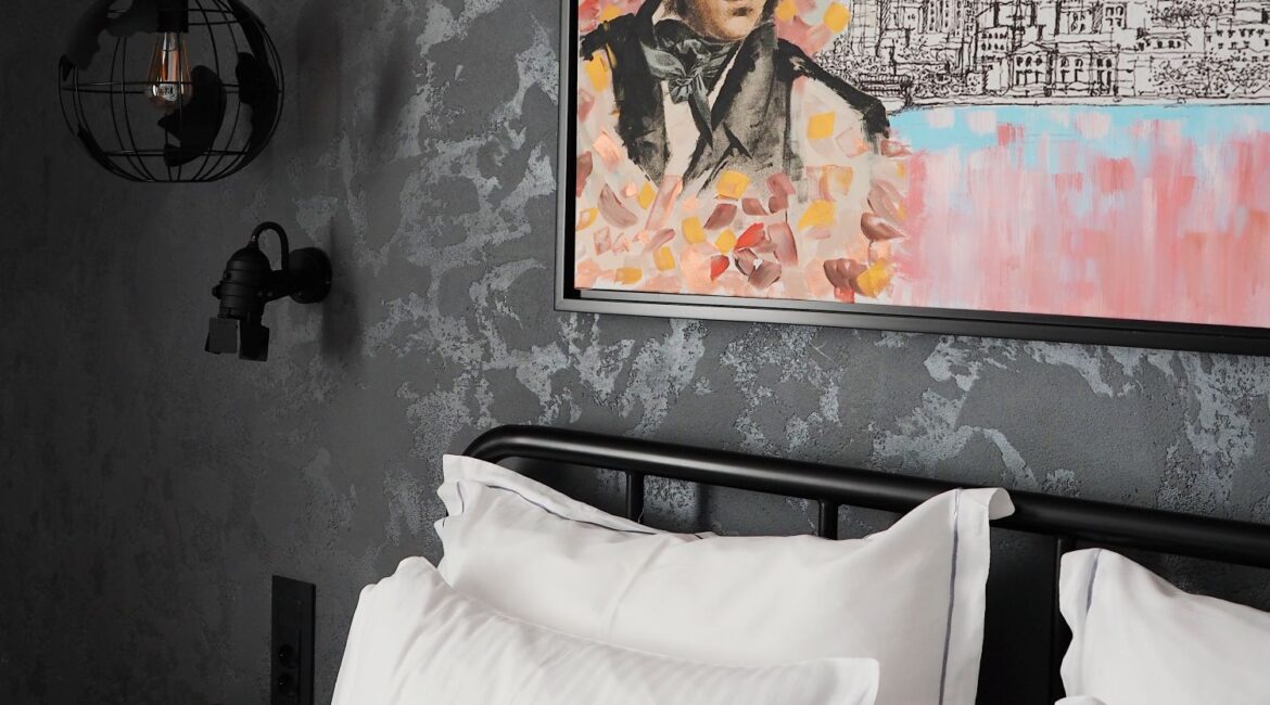 Detail of superior room at Hotel Poem in Istanbul featuring contemporary portrait artwork and soft textiles