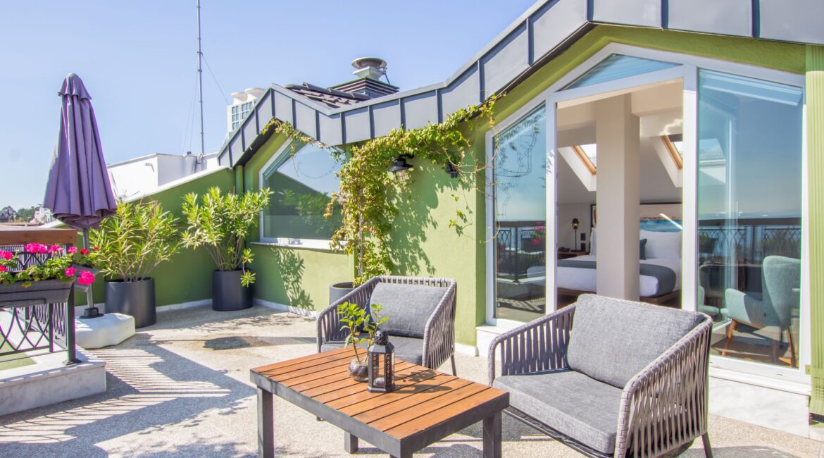 Penthouse terrace at Hotel Poem in Istanbul with outdoor seating and greenery overlooking the city