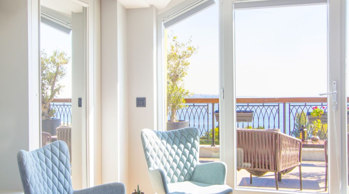 Sunlit corner of penthouse at Hotel Poem, Sultanahmet, with lounge chairs and bosphorus-facing windows