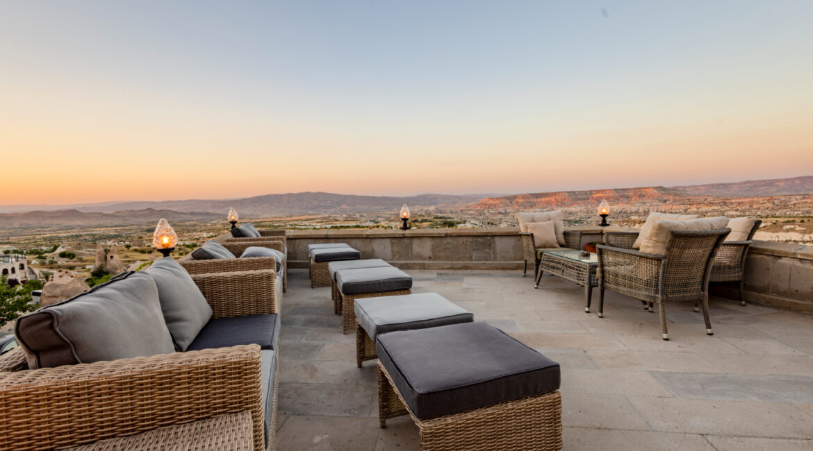 Outdoor lounge terrace with seating overlooking Cappadocia’s national park landscape