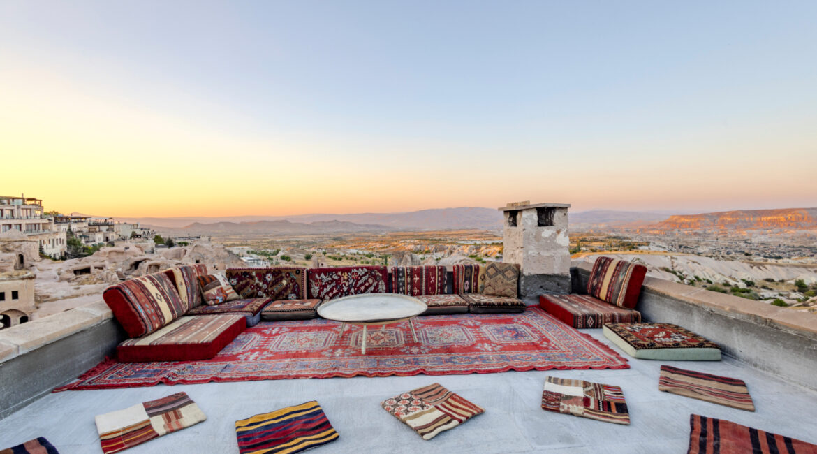 Rooftop köşk seating area with traditional cushions overlooking Cappadocia