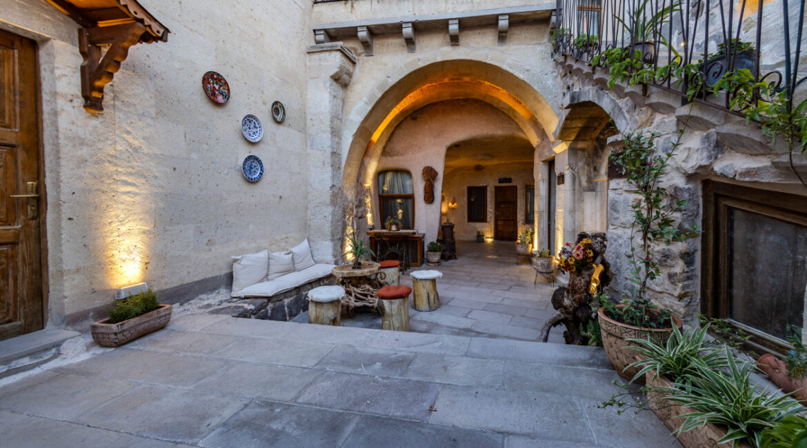 Stone courtyard entrance at Eyes of Cappadocia with traditional architecture in Uchisar