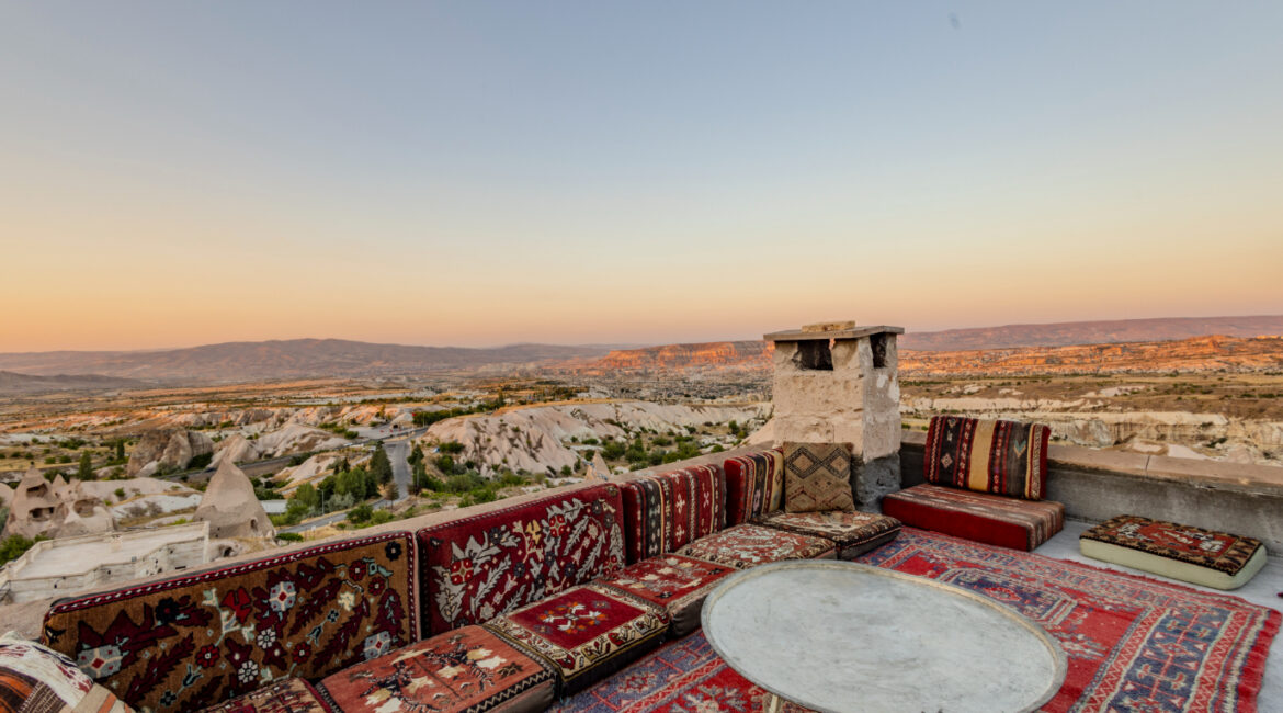 Sunset terrace with Turkish floor seating and views over Uchisar and surrounding valleys