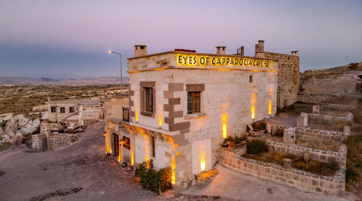 Exterior of Eyes of Cappadocia illuminated at dusk in Uchisar