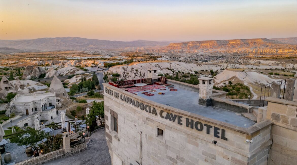 View across Cappadocia’s valleys from Uchisar with hotel rooftops in the foreground