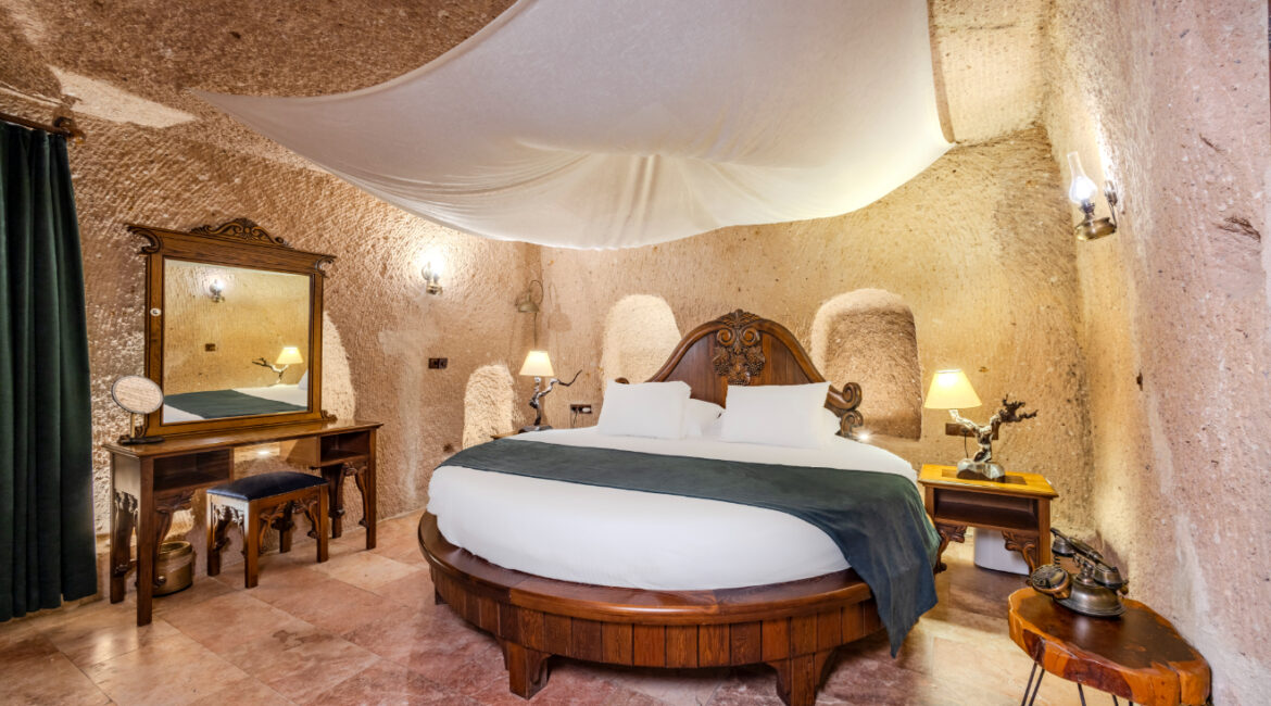 Shehrazat Deluxe Suite No 103 with carved stone interiors and king-size bed in Cappadocia cave hotel