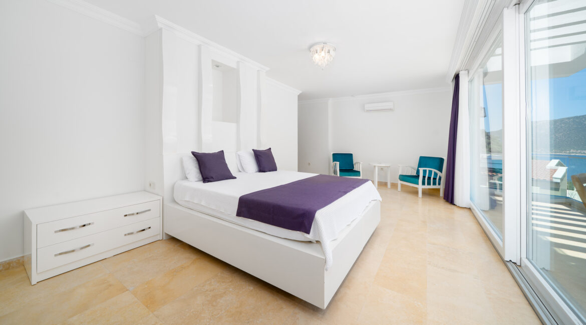 Bright bedroom at Villa Cennet Koy Kalkan with minimalist interiors and large windows