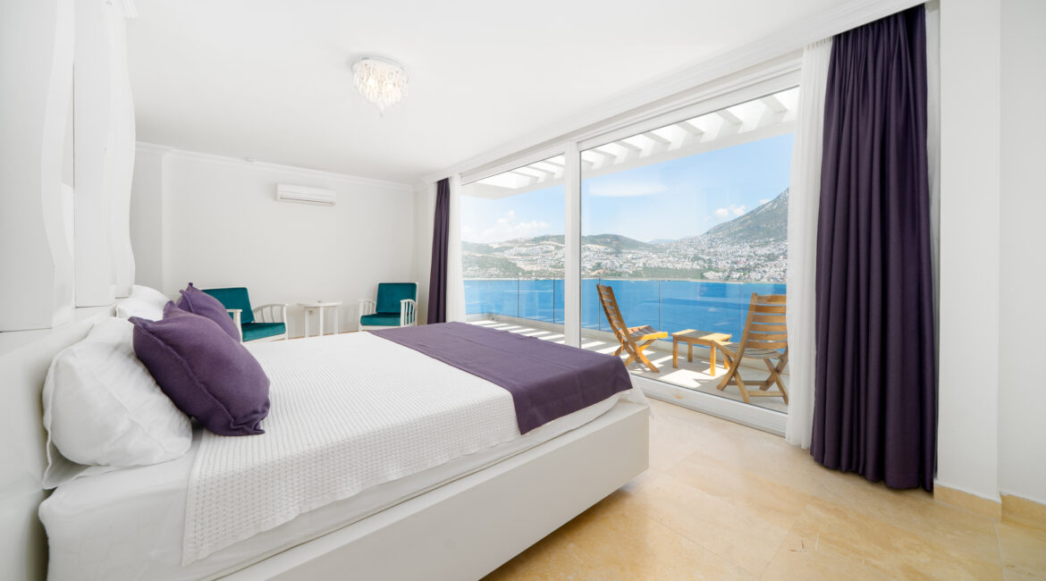 Modern double bedroom at Villa Cennet Koy Kalkan with floor-to-ceiling windows and sea views
