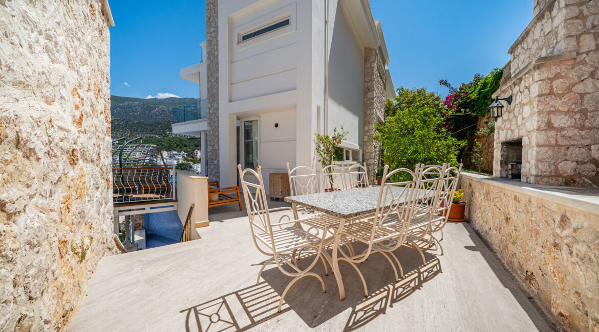Outdoor dining terrace at Villa Cennet Koy Kalkan with table and views across the bay