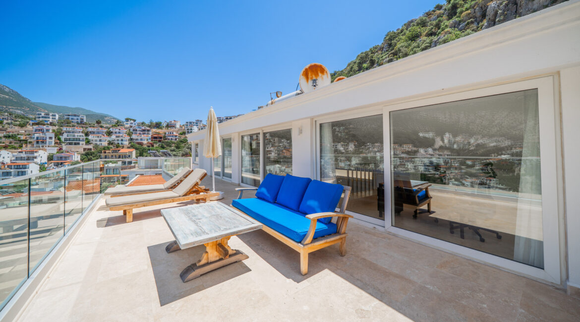Penthouse terrace at Villa Cennet Koy Kalkan with sun loungers and views across Kalkan harbour
