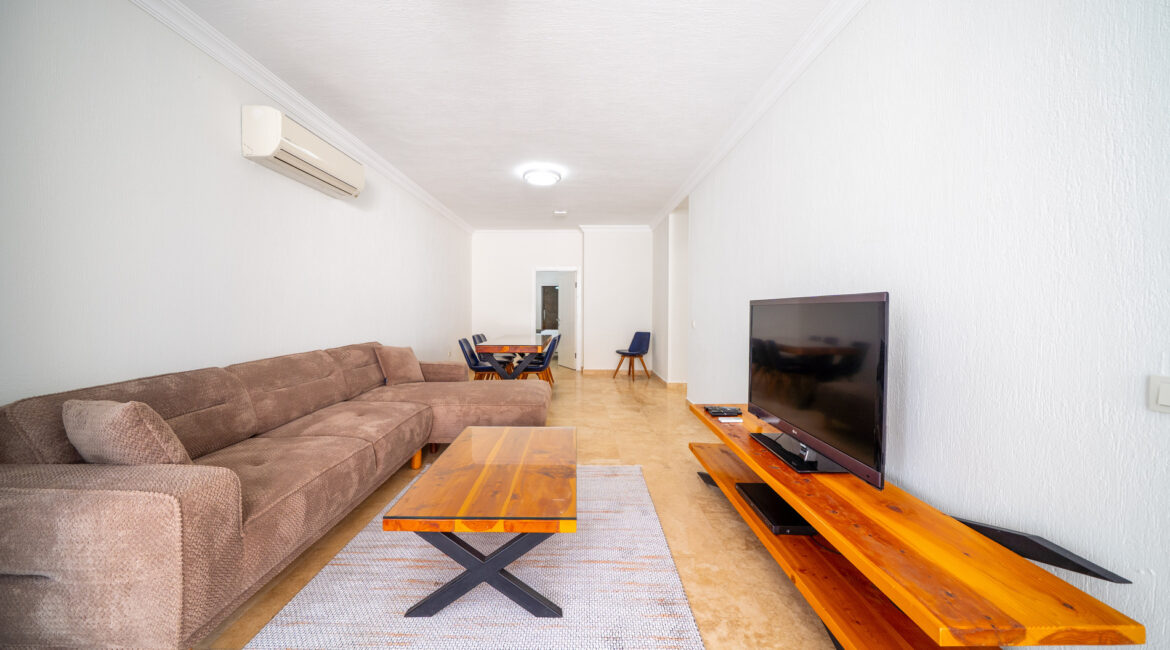 sitting area at Villa Cennet Koy Kalkan with wooden table and television