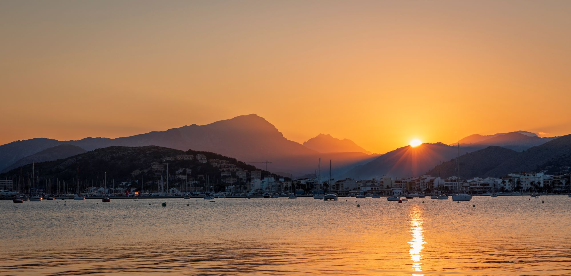 Sunset over the sea with mountain silhouettes in Mallorca