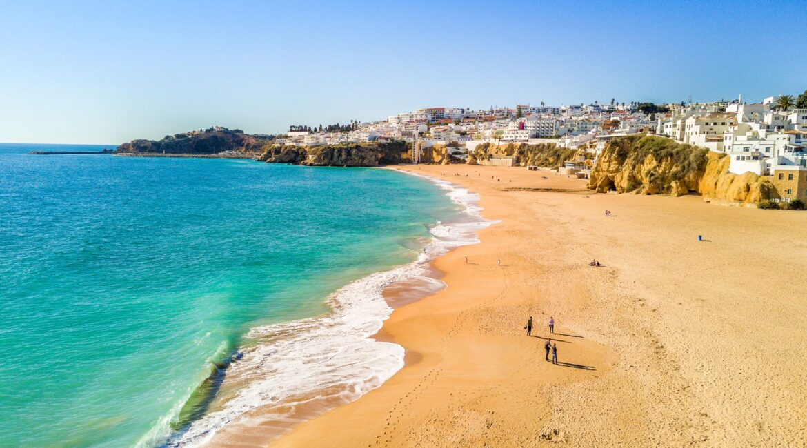 Golden sandy beach backed by cliffs along the Algarve coastline