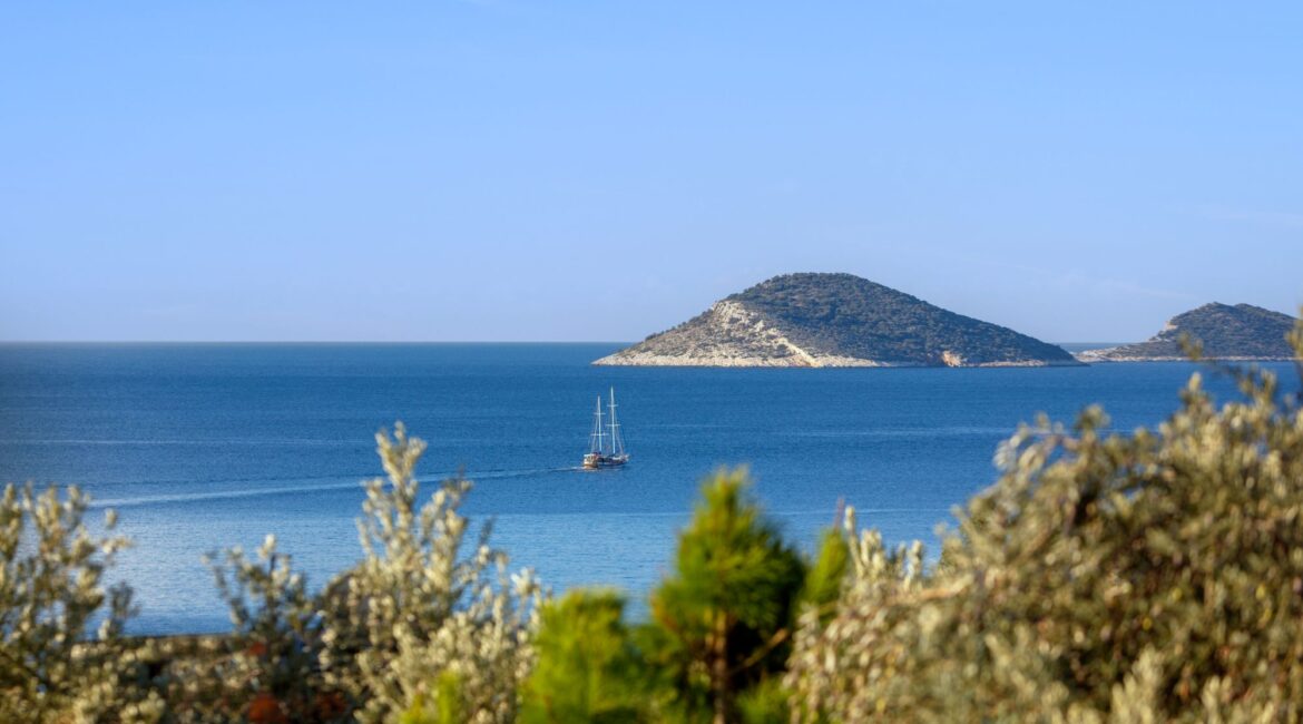 Island view from Kalkan coastline with crystal-clear Mediterranean waters