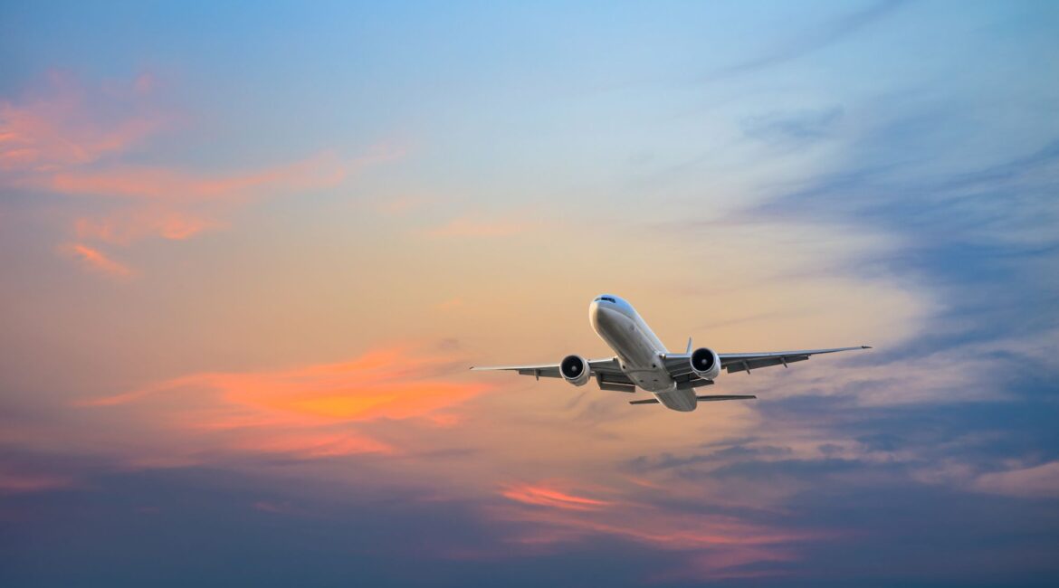 easyJet-style aircraft flying at sunset representing summer 2026 flights with no fuel surcharges