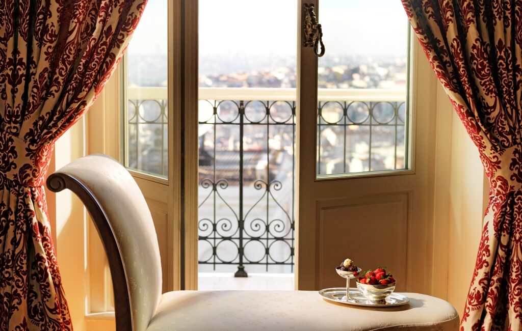 Sofa seating and balcony view in Deluxe Golden Horn Room at Pera Palace Hotel Istanbul