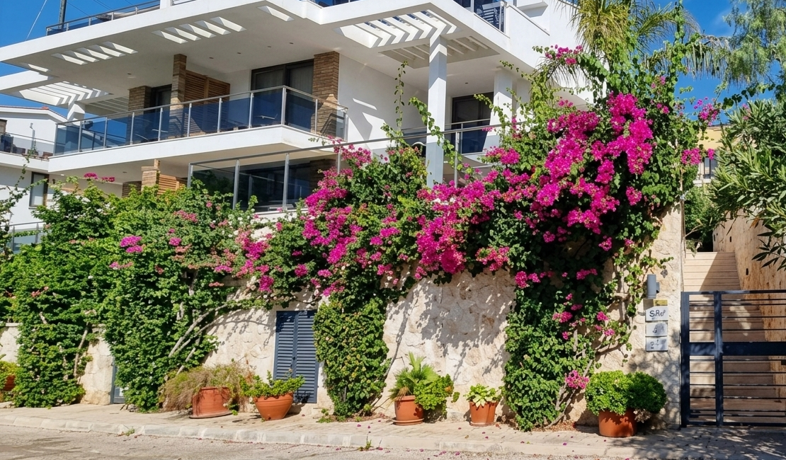Exterior view of Topaz Penthouse at Mavi Su House in Kalkan surrounded by bougainvillea and Mediterranean greenery