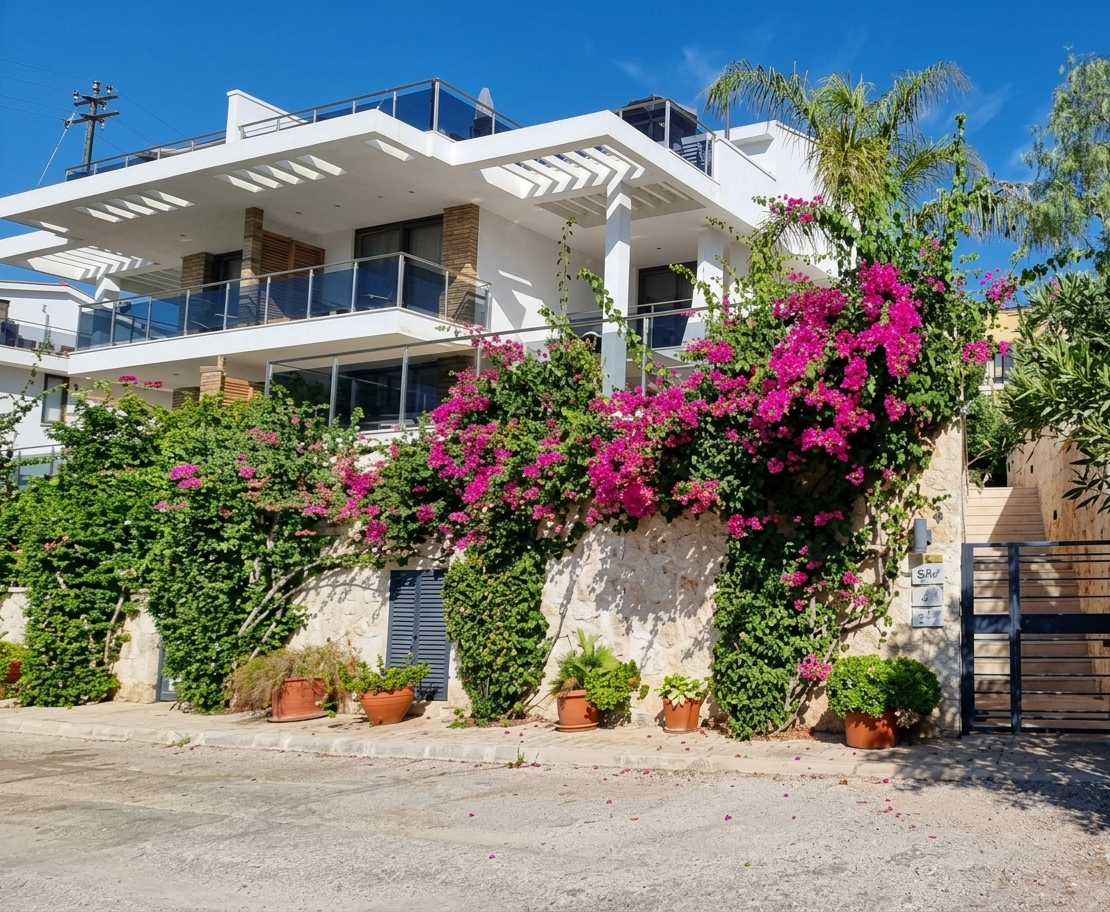 Exterior view of Topaz Penthouse at Mavi Su House in Kalkan surrounded by bougainvillea and Mediterranean greenery