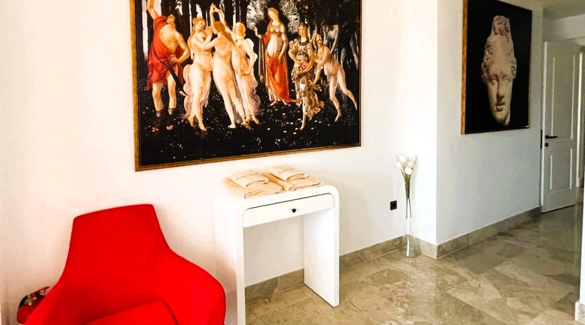 Elegant bedroom entrance area with contemporary artwork and marble flooring at Topaz Penthouse Kalkan