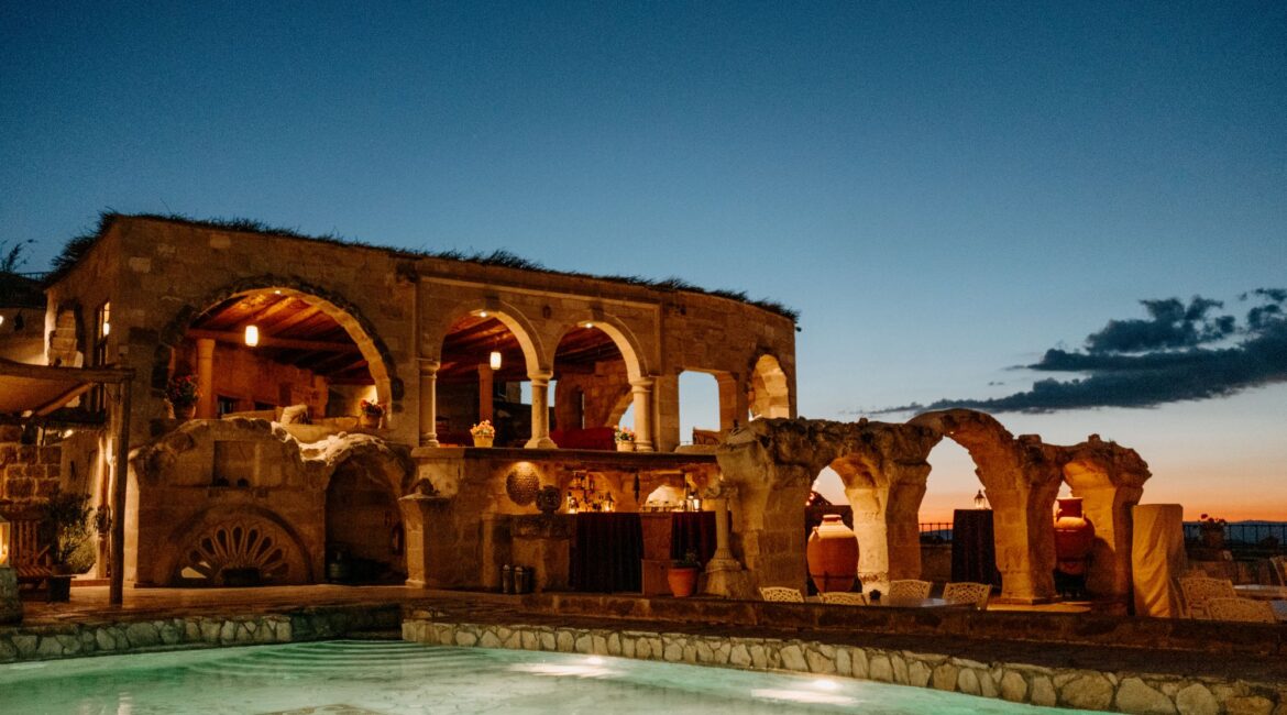 Heated Roman-style pool at Museum Hotel Cappadocia overlooking the valleys at sunset in Uchisar