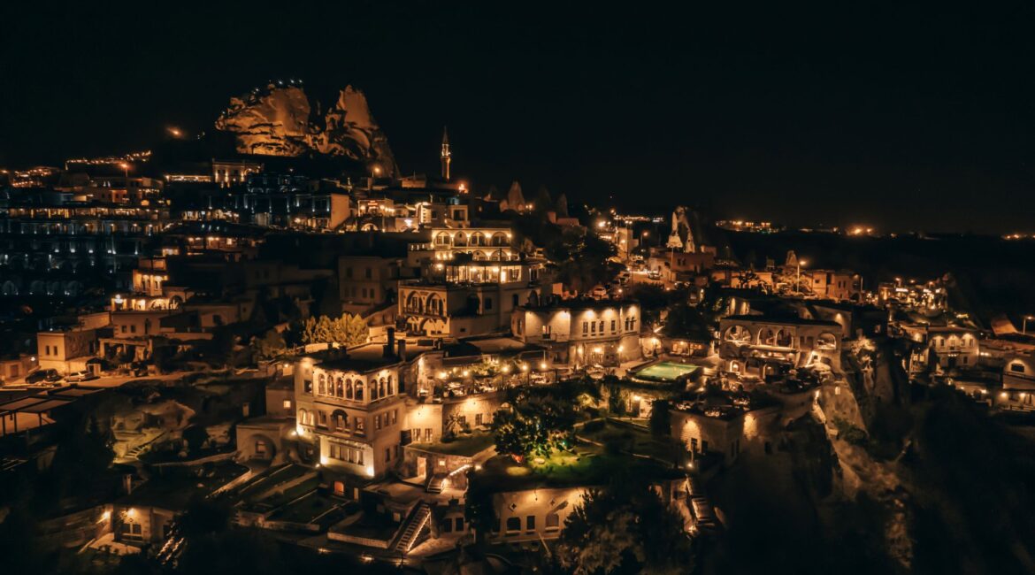 Museum Hotel Cappadocia illuminated at night beneath Uchisar Castle