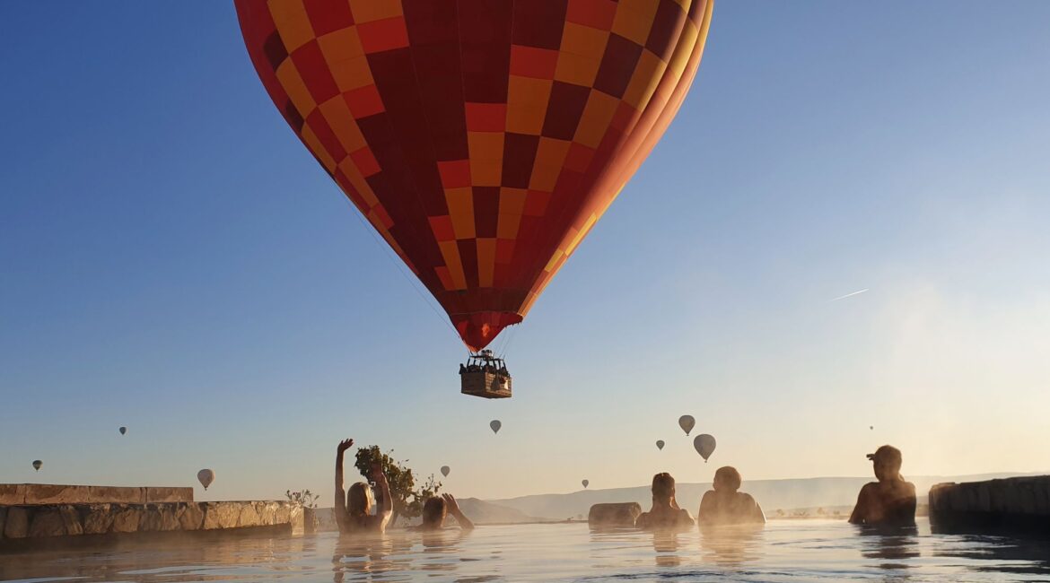 Hot-air balloon floating above the pool terrace at Museum Hotel Cappadocia