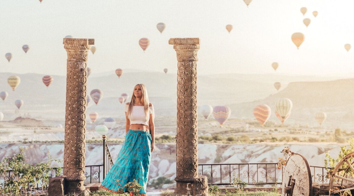 Guest enjoying hot-air balloon views from the terrace at Museum Hotel Cappadocia