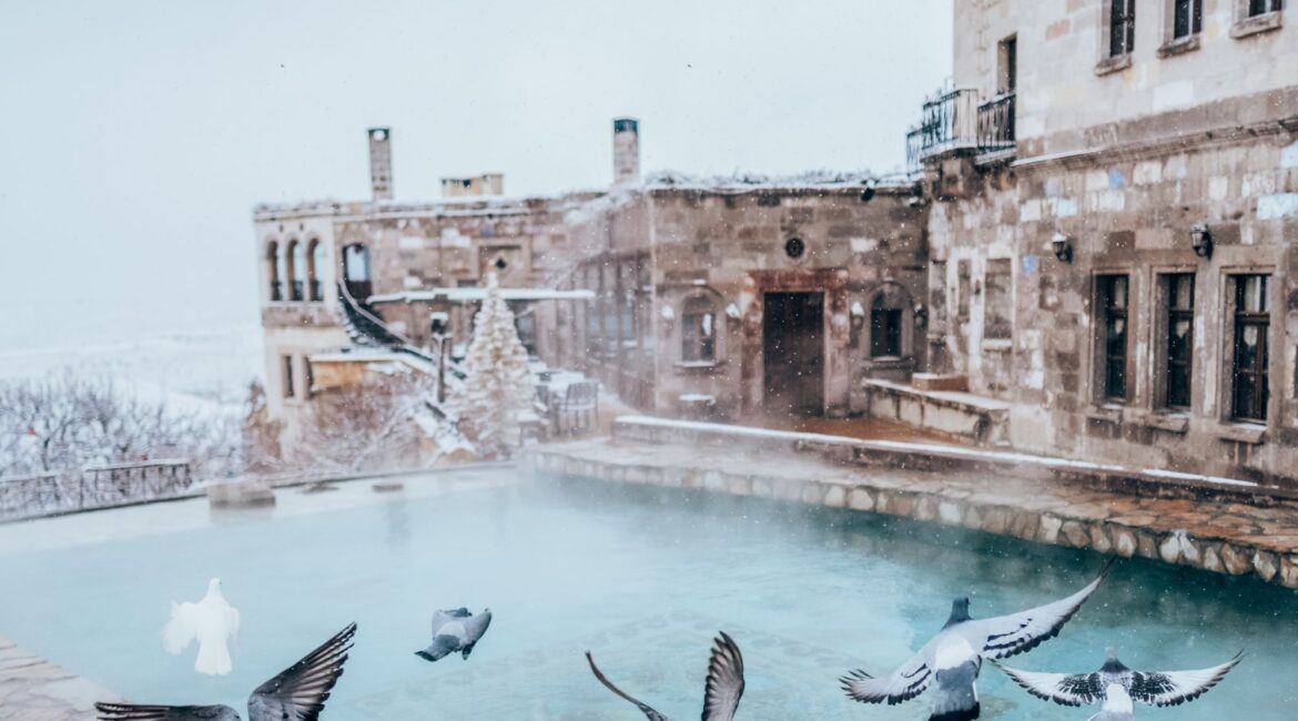 Heated Roman-style pool at Museum Hotel Cappadocia during winter snowfall