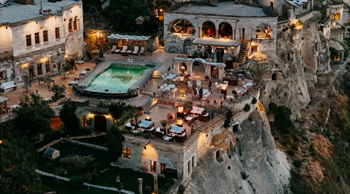 Aerial evening view of Museum Hotel Cappadocia in Uchisar overlooking the valleys